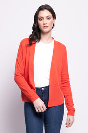 A model wearing the Merino Wool Always Love Ewe Cardigan in colour Flash (Red), from the front, cropped image