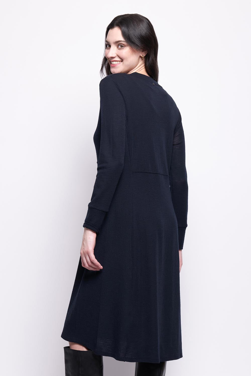 A model wearing the Merino Shear Ecstasy Dress in colour Truenavy (Blue), from the back