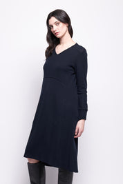 A model wearing the Merino Shear Ecstasy Dress in colour Truenavy (Blue), from the front, cropped image
