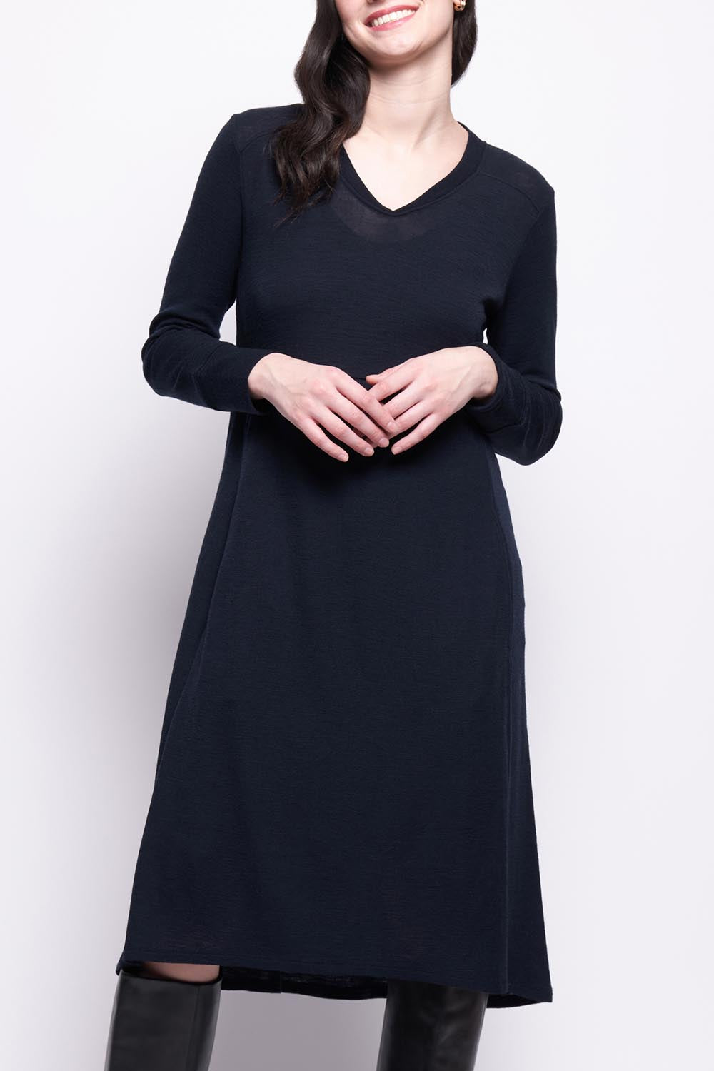 A model wearing the Merino Shear Ecstasy Dress in colour Truenavy (Blue), from the front, cropped image