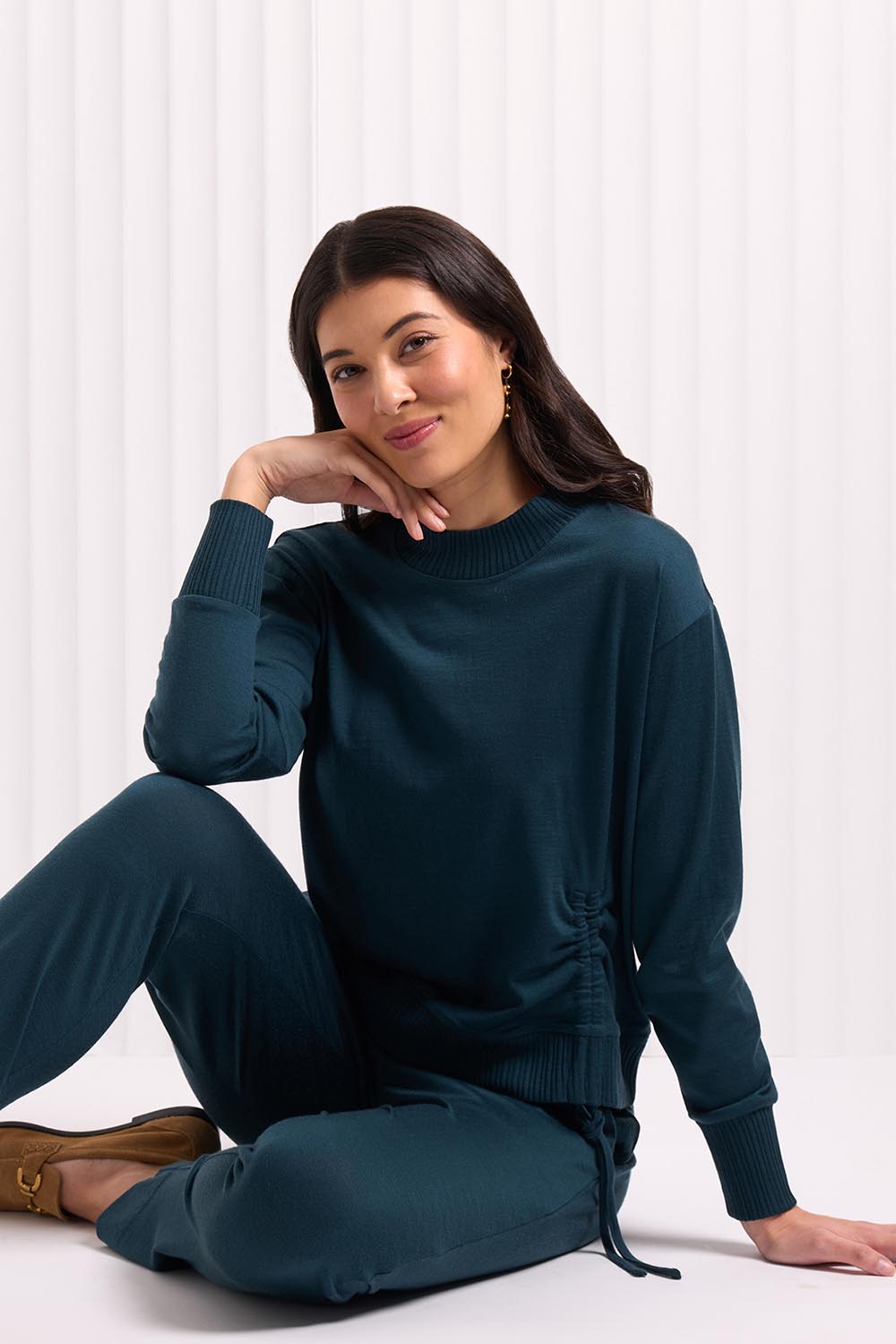 A model wearing the Merino Best Side Top in colour Jeep (Green), from the front, cropped image