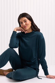 A model wearing the Merino Best Side Top in colour Jeep (Green), from the front, cropped image