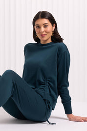 A model wearing the Merino Best Side Top in colour Jeep (Green), from the front, cropped image