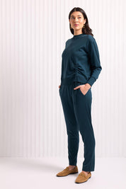 A model wearing the Merino Best Side Top in colour Jeep (Green), from the front, showing the whole outfit
