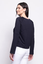 A model wearing the Merino Belong Together Sweater in colour Futuredusk (Blue), from the back