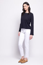 A model wearing the Merino Belong Together Sweater in colour Futuredusk (Blue), from the front, showing the whole outfit