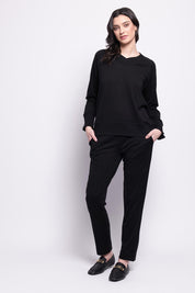 A model wearing the Merino Lazy Sunday Jogger in colour Black (Black), from the front, showing the whole outfit