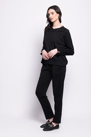A model wearing the Merino Lazy Sunday Jogger in colour Black (Black), from the front, showing the whole outfit