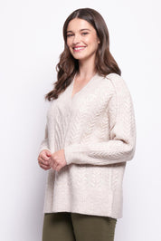A model wearing the She's A Purla Sweater in colour Natural, from the front, cropped image