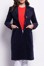 A model wearing the For The Rein colourCord Coat - Midnight (Blue), from the front, cropped image