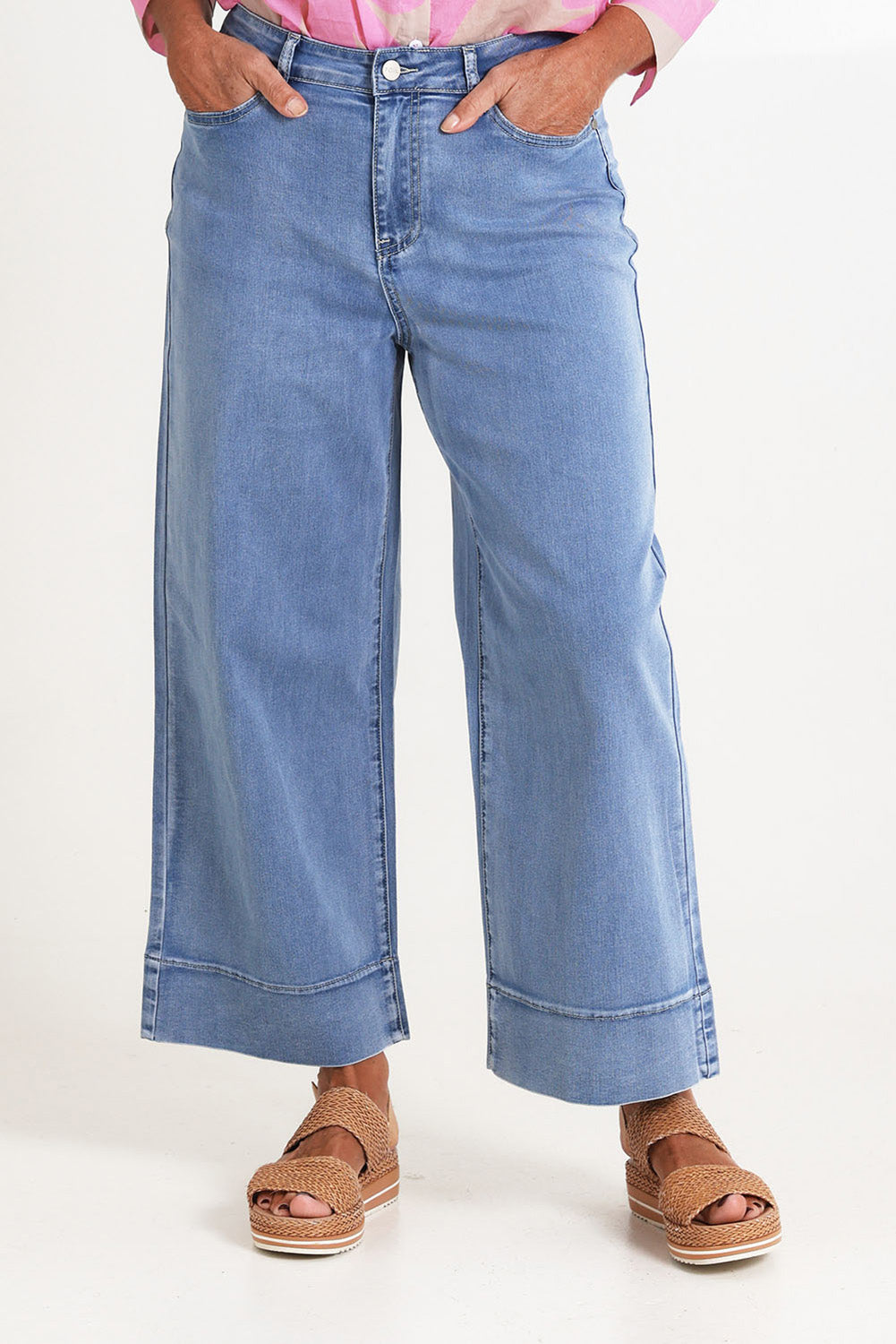 Model Sandy wearing size 10 of the Jean Queen Crop in colour Bluewash (Blue), from the front, cropped image