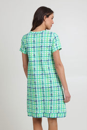 Model Madeline wearing size S of the Oh Frock Cotton Dress in colour Edgy (Green), from the back
