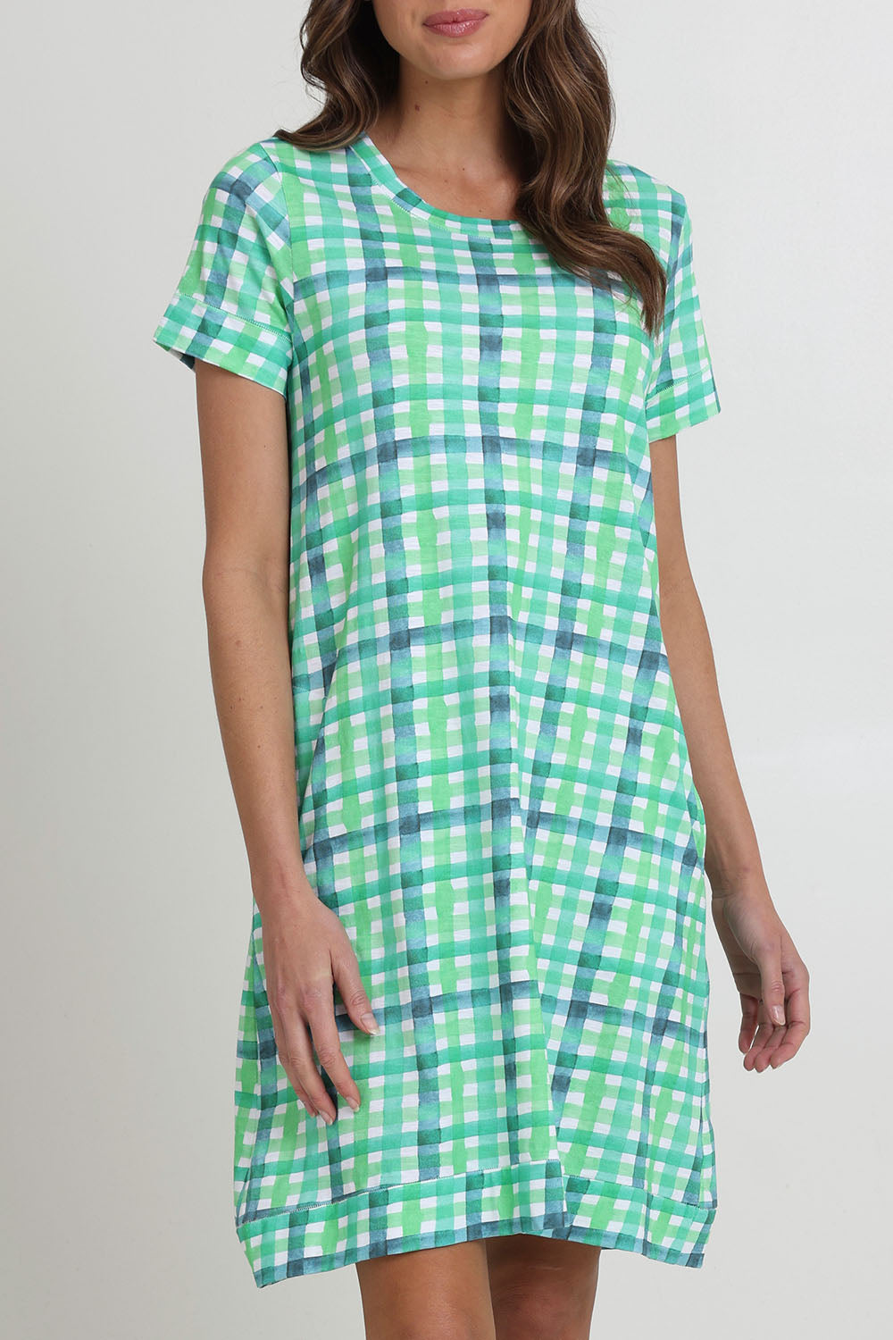 Model Madeline wearing size S of the Oh Frock Cotton Dress in colour Edgy (Green), from the front, cropped image