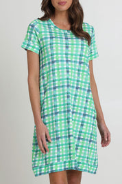 Model Madeline wearing size S of the Oh Frock Cotton Dress in colour Edgy (Green), from the front, cropped image