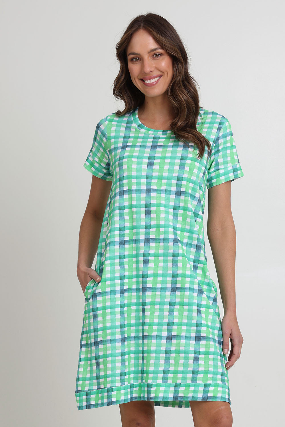Model Madeline wearing size S of the Oh Frock Cotton Dress in colour Edgy (Green), from the front, cropped image