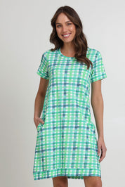 Model Madeline wearing size S of the Oh Frock Cotton Dress in colour Edgy (Green), from the front, cropped image