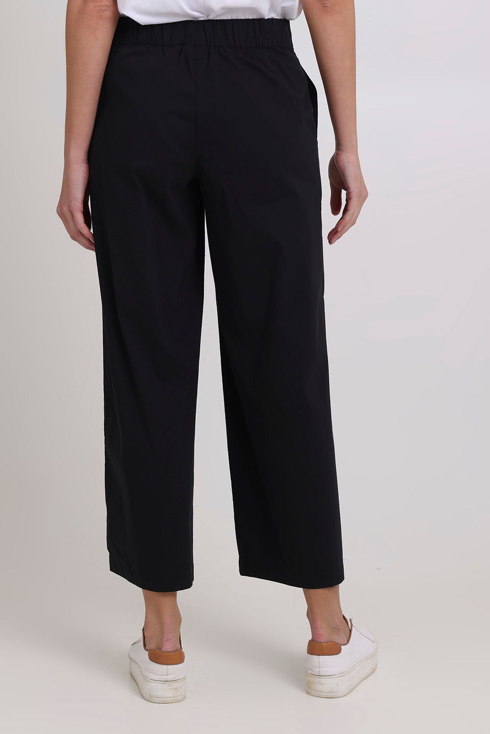 Model Madeline wearing size 10 of the Broad Horizons Cotton Blend Pant in colour Black (Black), from the back