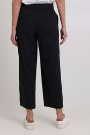 Model Madeline wearing size 10 of the Broad Horizons Cotton Blend Pant in colour Black (Black), from the back