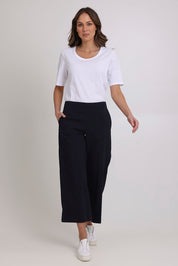 Model Madeline wearing size 10 of the Broad Horizons Cotton Blend Pant in colour Truenavy (Blue), from the front, showing the whole outfit