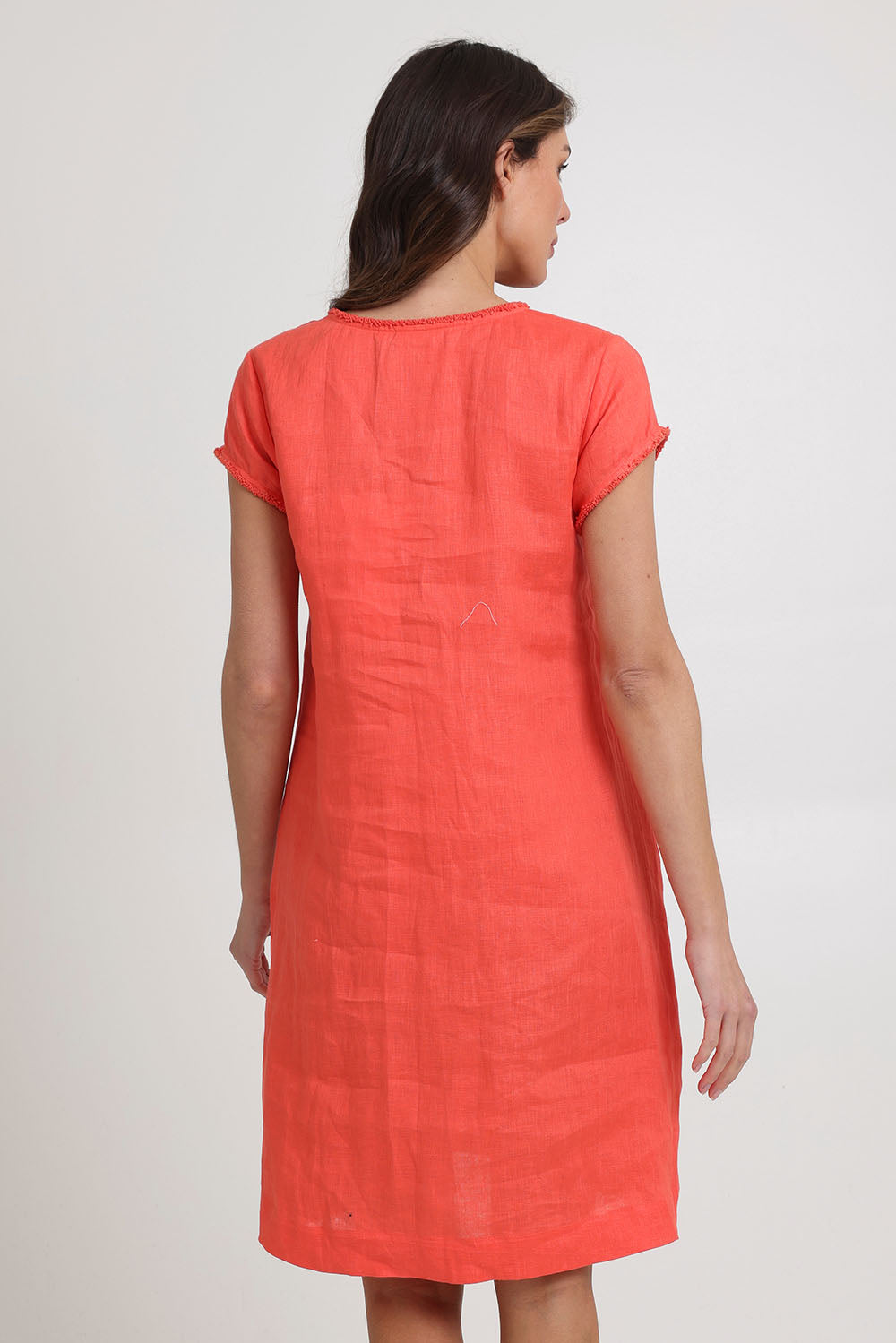 Model Madeline wearing size 10 of the Festival Linen Dress in colour Melon (Pink), from the back