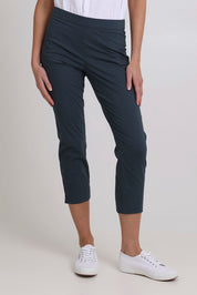 Model Madeline wearing size 10 of the Fuss Free 7/8 Pant in colour Basalt (Grey), from the front, cropped image