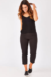 Model Laura wearing size 12 of the Fuss Free 7/8 Pant in colour Black (Black), from the front, showing the whole outfit