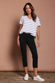 Model Madeline wearing size 10 of the Fuss Free 7/8 Pant in colour Black (Black), from the front, showing the whole outfit