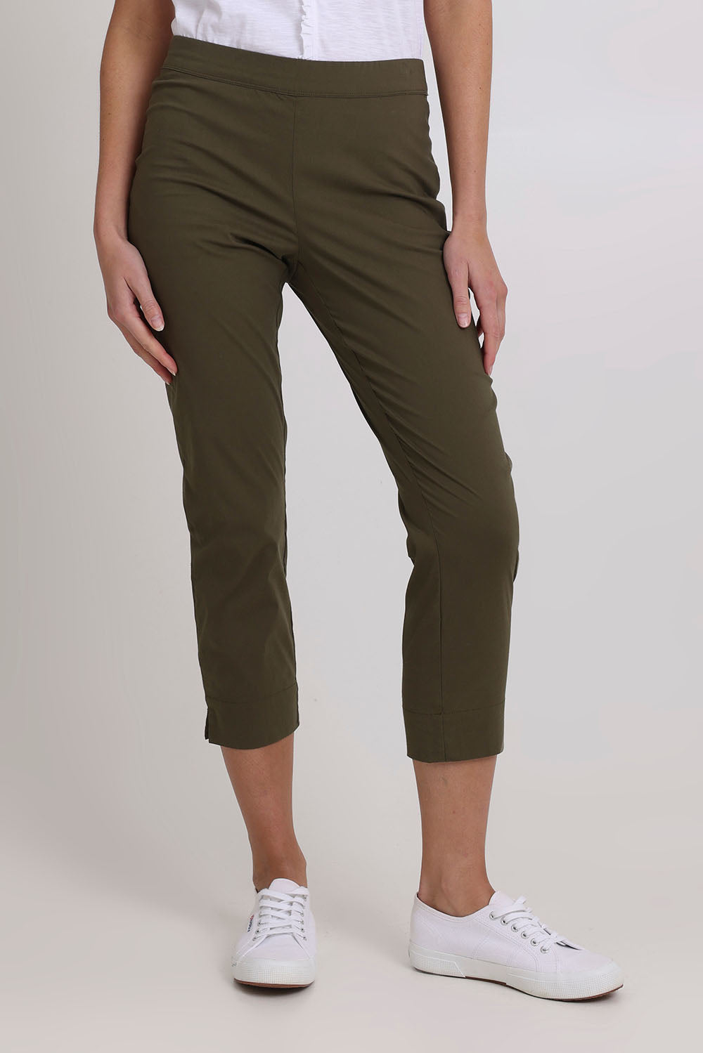 Model Madeline wearing size 10 of the Fuss Free 7/8 Pant in colour Kelp (Green), from the front, cropped image