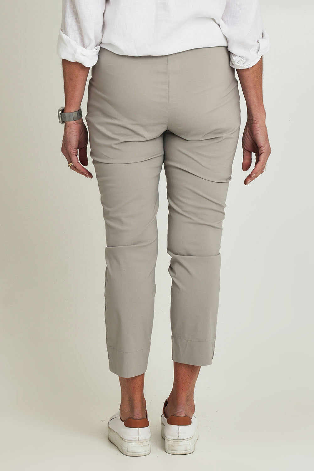 Model Sandy wearing size 10 of the Fuss Free 7/8 Pant in colour Lightkhaki (Green), from the back
