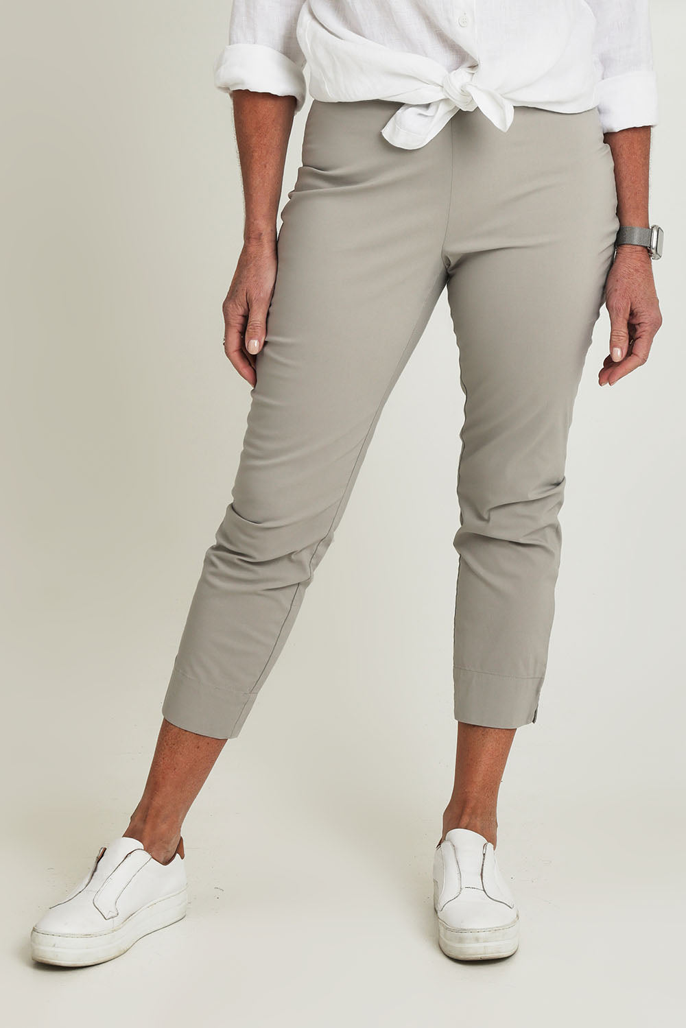 Model Sandy wearing size 10 of the Fuss Free 7/8 Pant in colour Lightkhaki (Green), from the front, cropped image