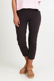 Model Riinar wearing size 10 of the Fuss Free 7/8 Pant – Sable in colour Sable, in a cropped view