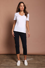 Model Madeline wearing size 10 of the Fuss Free 7/8 Pant in colour TrueNavy (Blue), from the front, showing the whole outfit