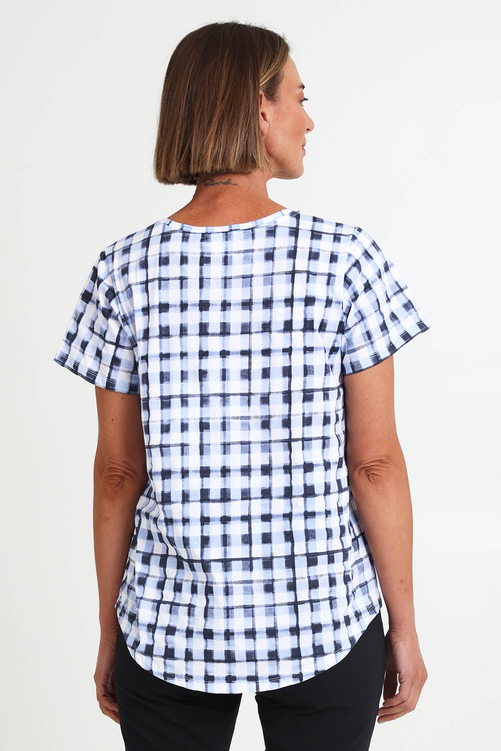 Model Riinar wearing size 10 of the Here Comes Summer Tee – Checkers in colour Checkers, from the back