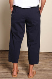 Model Riinar wearing size 10 of the Pump It Up Pant – Navy in colour Navy, from the back