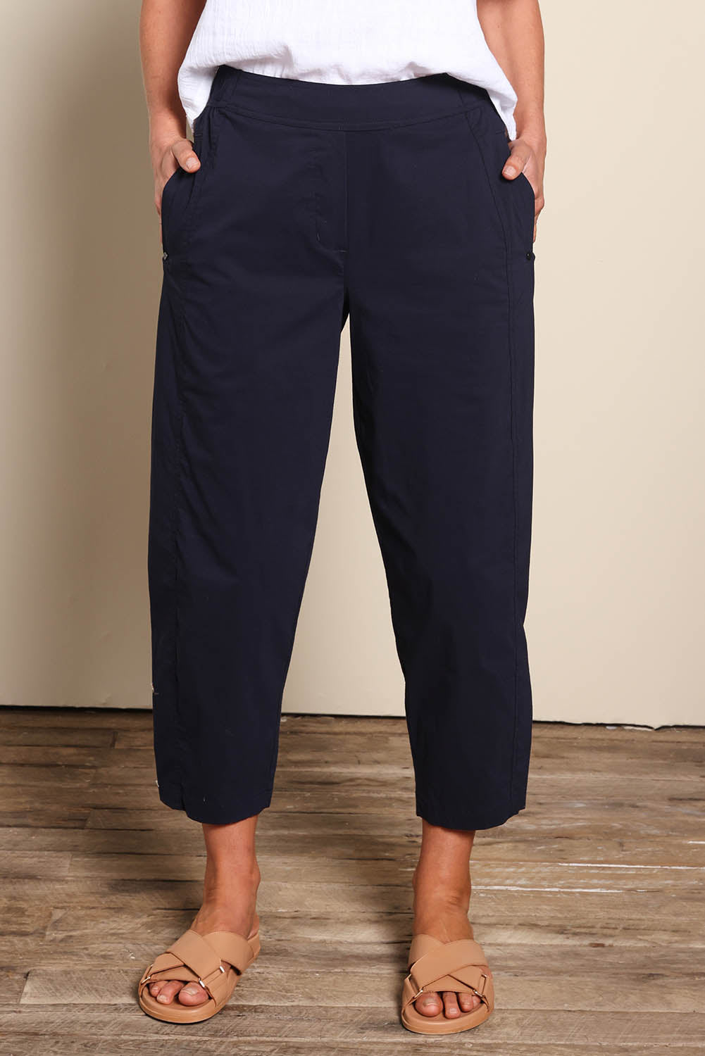 Model Riinar wearing size 10 of the Pump It Up Pant – Navy in colour Navy, from the front
