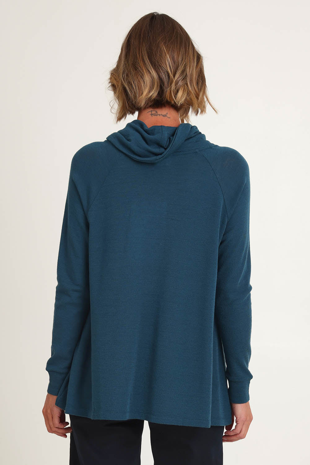 Model Riina wearing size S of the Good Stakes Top in colour Green (Green), from the back