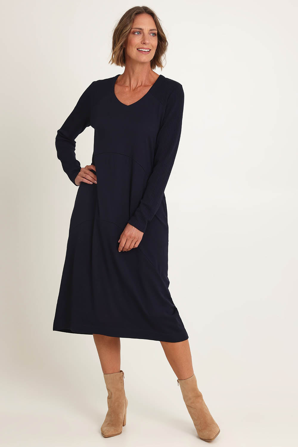 Model Riina wearing size S of the Upper Cut Dress in colour Nightsky (Blue), from the front, showing the whole outfit