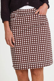 Model Riinar wearing size 10 of the Tee Riffic Skirt – Checkit in colour Checkit, from an angle