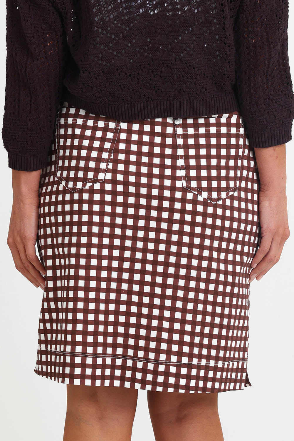 Model Riinar wearing size 10 of the Tee Riffic Skirt – Checkit in colour Checkit, from the back