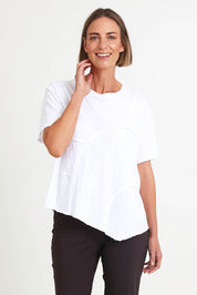 Model Riinar wearing size 10 of the Spliced And Diced Tee – White in colour White, in a cropped view