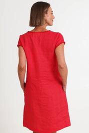 Model Riinar wearing size 10 of the V Festival Dress – Melon in colour Melon, from the back