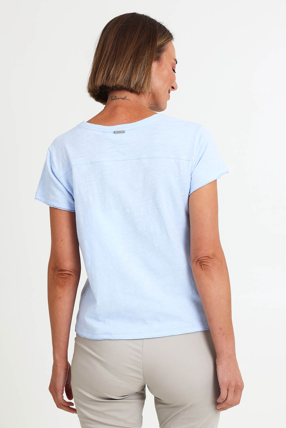 Model Riinar wearing size 10 of the Intersection Tee – Sky in colour Sky, from the back