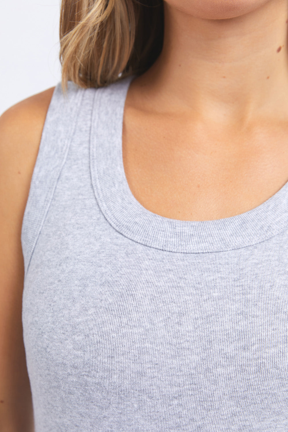 A model wearing the Esme Cotton Tank in colour Greymarle (Grey), from the front, cropped image