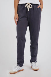 A model wearing the Elements Monday Cotton Pant in colour Coal (Grey), from the front, cropped image