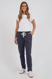 A model wearing the Elements Monday Cotton Pant in colour Coal (Grey), from the front, showing the whole outfit