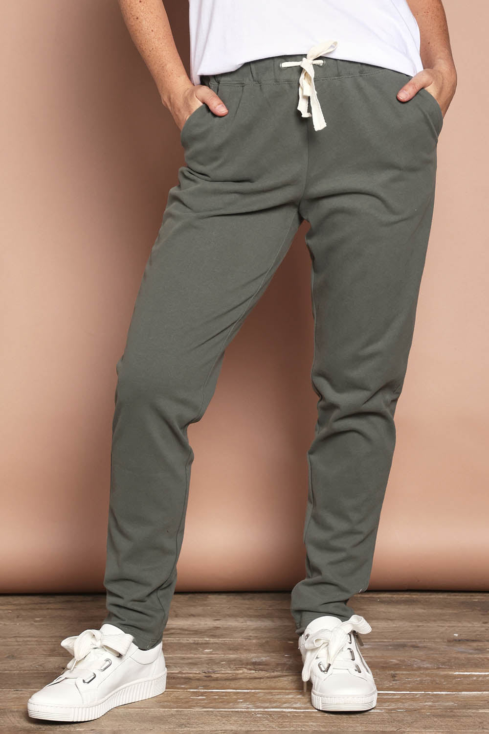 Model Katie wearing size 8 of the Elements Monday Cotton Pant in colour Khaki (Green), from the front, cropped image