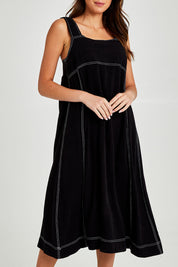 Model Madeline wearing size 10 of the Sage Dress in colour Black (Black), from the front, cropped image