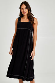 Model Madeline wearing size 10 of the Sage Dress in colour Black (Black), from the front, cropped image