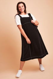 Model Poppy wearing size 16 of the Sage Dress in colour Black (Black), from the front, showing the whole outfit
