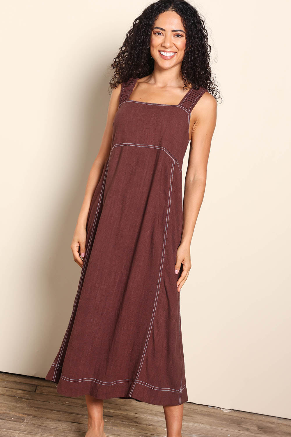 Model Pamelar wearing size 10 of the Sage Dress – Chocolate in colour Chocolate, from the front